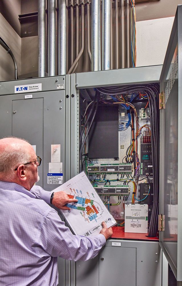 Technician wiring a commercial control panel